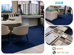 บรรยากาศบูธขายคอนโดและสำนักงานขาย ตกแต่งพื้นด้วยพรมลูกฟูกสีน้ำเงินเข้ม พร้อมมุมเจรจาและโมเดลโครงการ